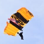photo of man with yellow Army parachute