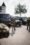 2 men standing near black car during daytime