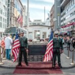 two men holding USA flags outdoors