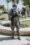 man in green and brown camouflage uniform holding brown rifle