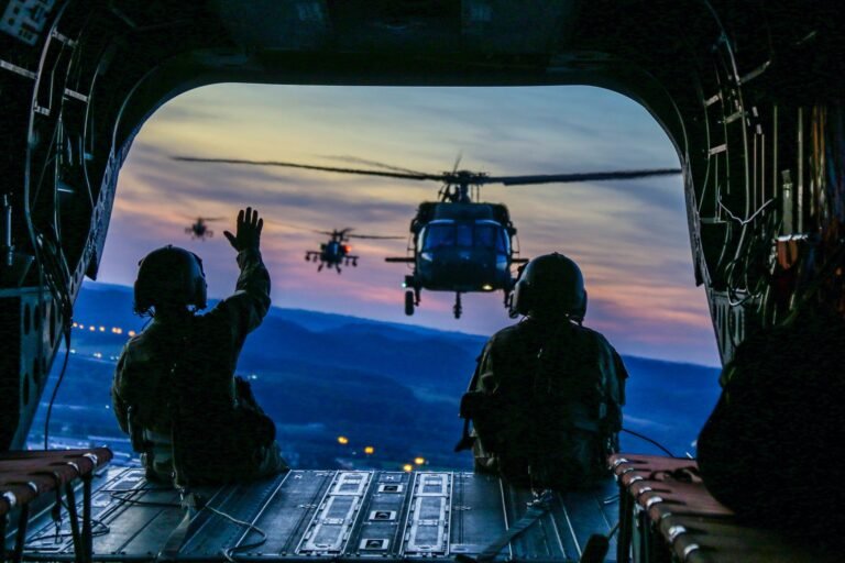 two soldiers on flying airplane with strap on back